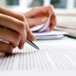 Close-up of secretarys hands doing paperwork